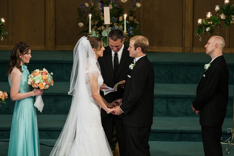 A bride and groom holding hands

Description automatically generated