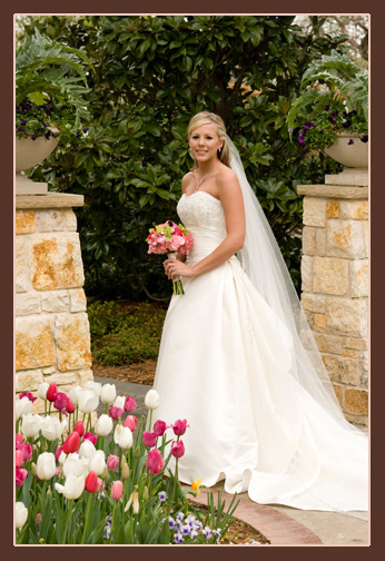 A person in a white dress holding flowers

Description automatically generated