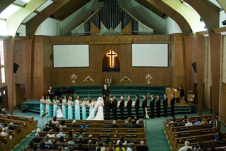 A wedding ceremony in a church

Description automatically generated